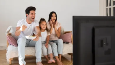 Una familia viendo TV juntos, con una pantalla de TV con varios dispositivos conectados