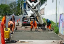 Trabajadores realizando obras de bacheo con hormigón en una intersección de Córdoba