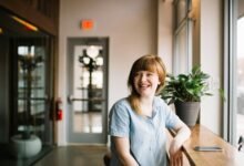 Persona sonriendo y ayudando a otra persona