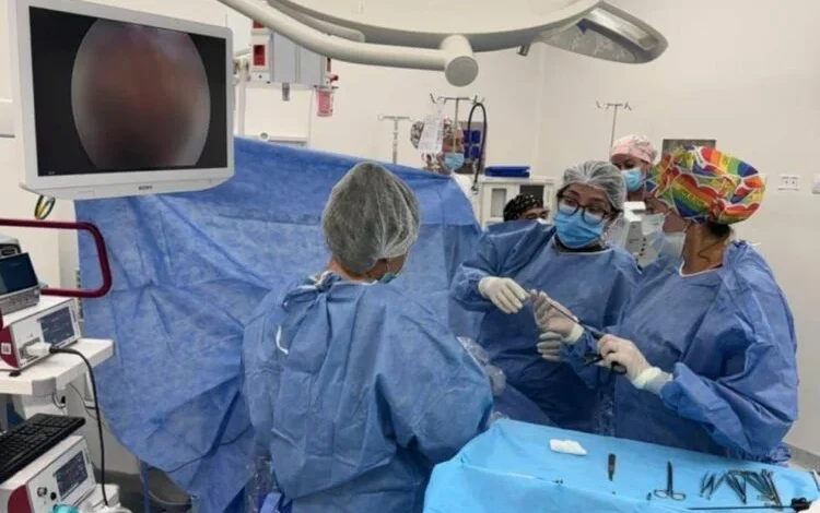 Equipo médico realizando una cirugía digestiva por laparoscopía en un recién nacido
