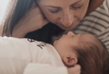 Mamá abrazando a su bebé, sonriendo