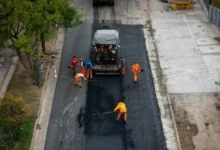 Obreros repavimentando la avenida General Paz en Córdoba durante la visita del Papa
