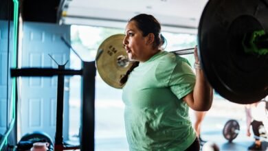 Persona entrenando en gimnasio con pesas, ilustrando la sobrecarga progresiva