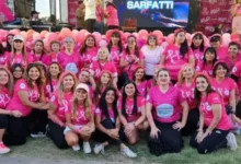 Participantes de la caminata 'Caminamos con vos' recorriendo el Parque Sarmiento bajo el lazo rosa